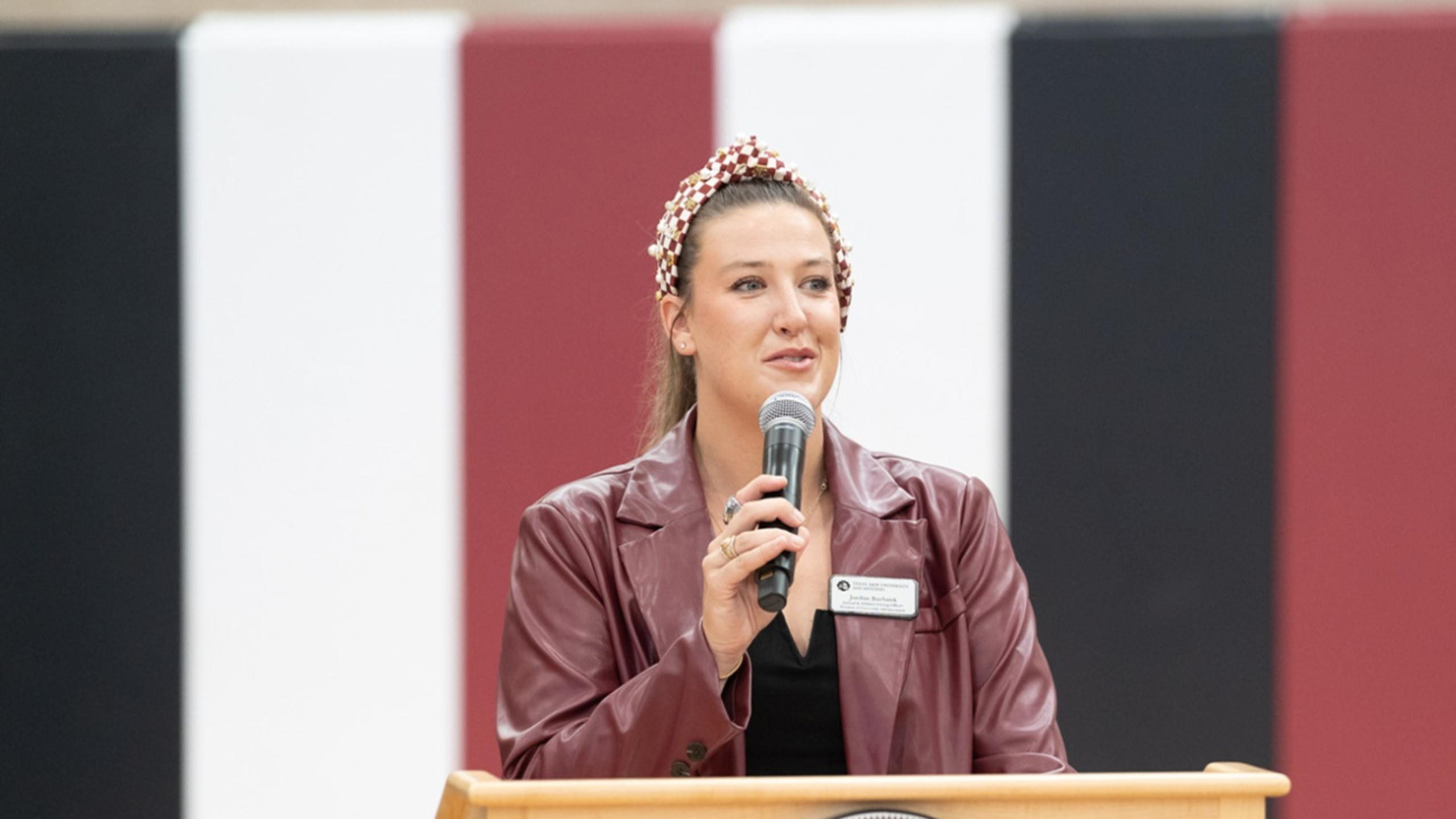 Jordan Burbank delivers a speech at a past event in the University Recreation Center. 