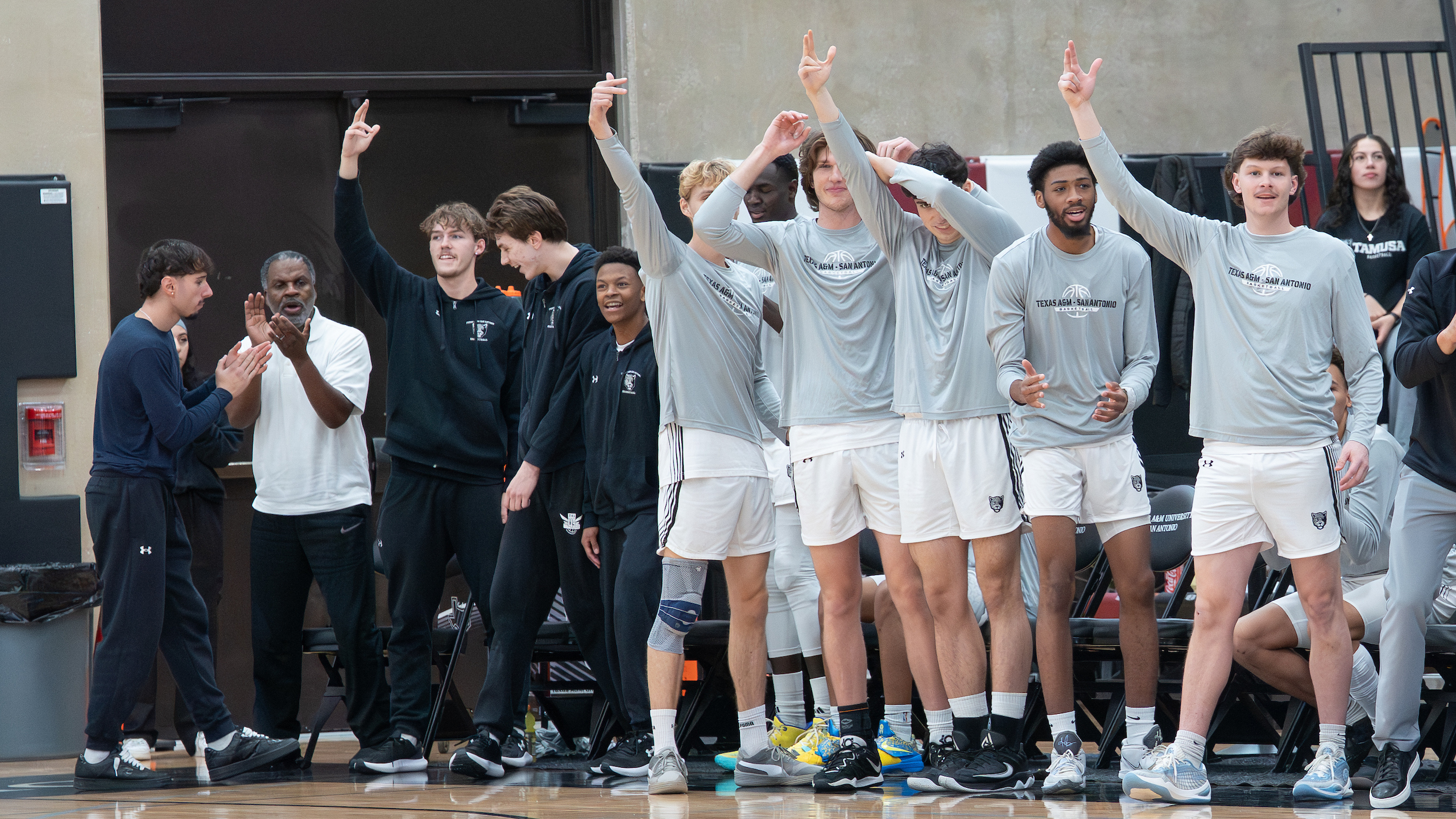 Members of the men's basketball team celebrate at an early season game. 