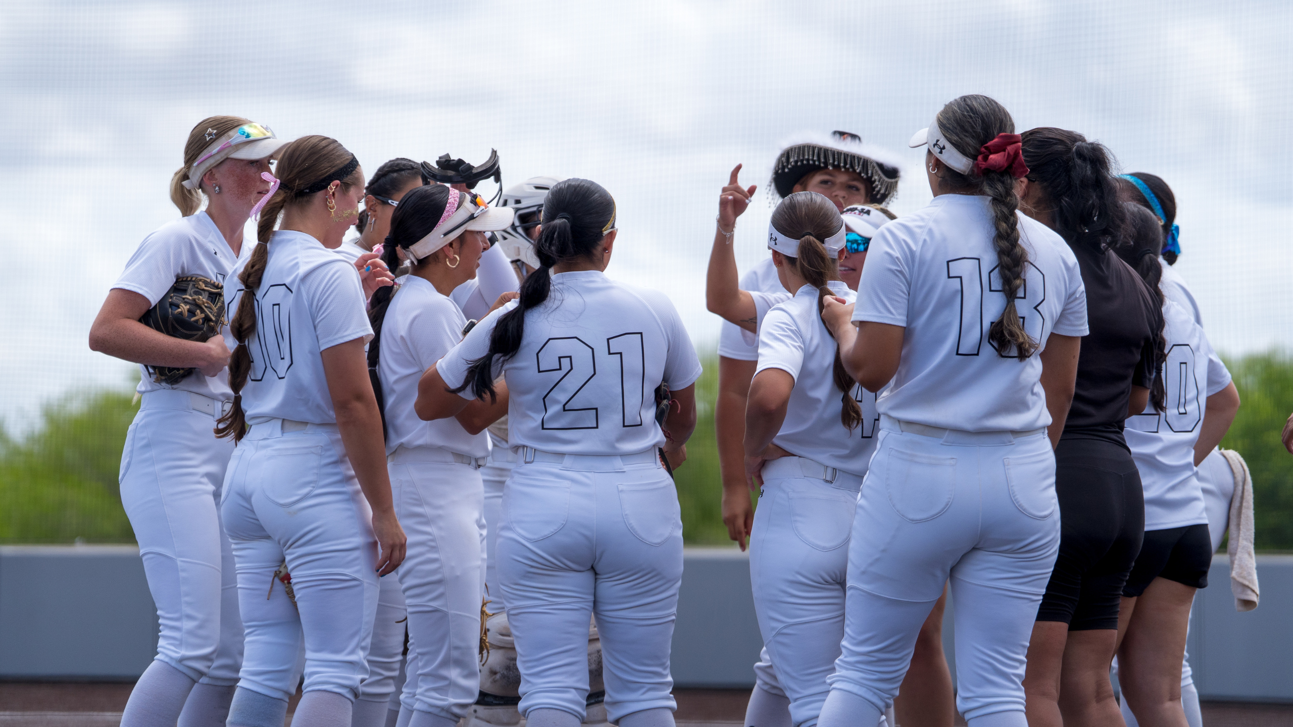 Members of the Jaguar softball team celebrate after winning a game against Xavier University. 